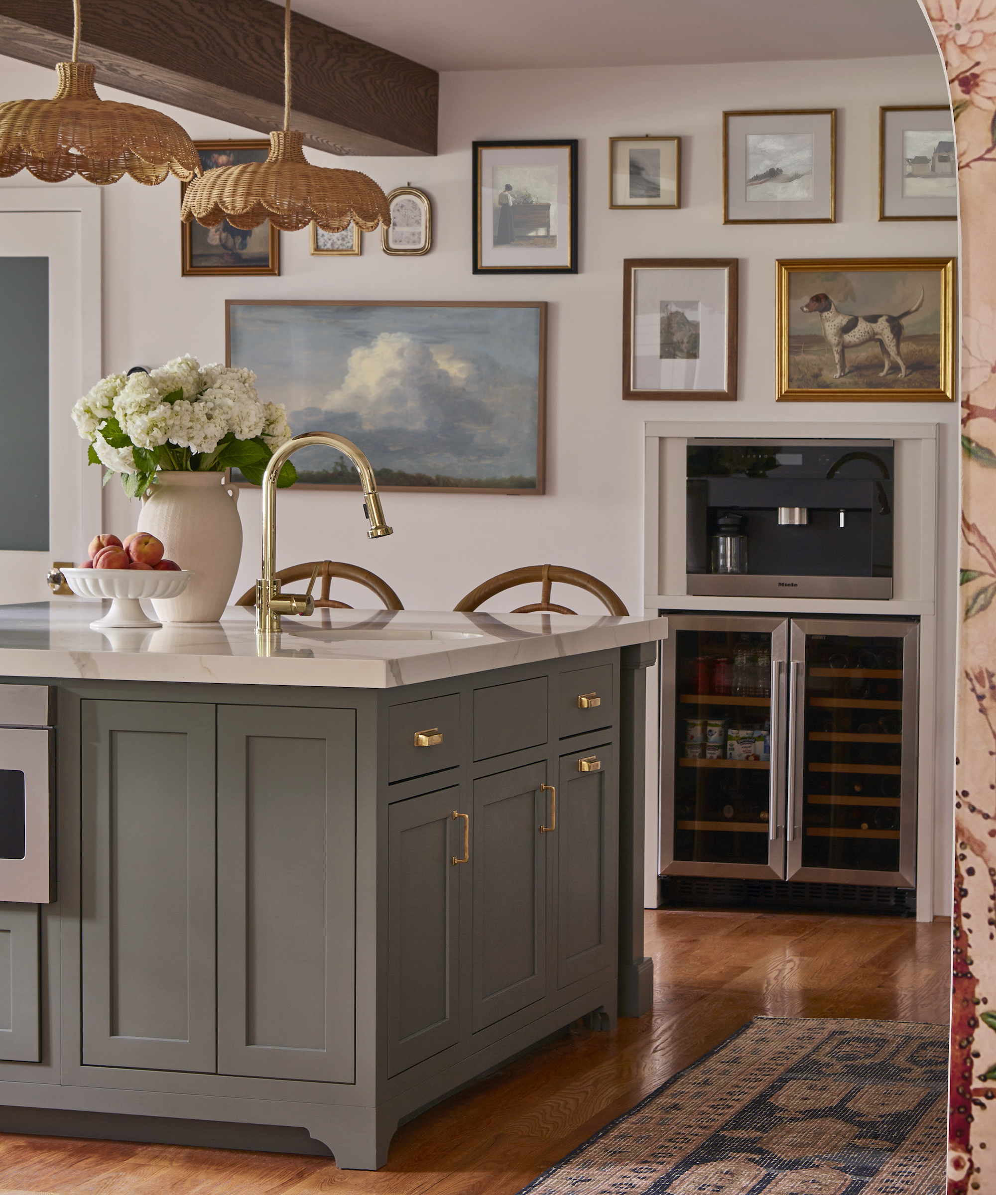 kitchen with island with tap and sink and wine fridge in the background