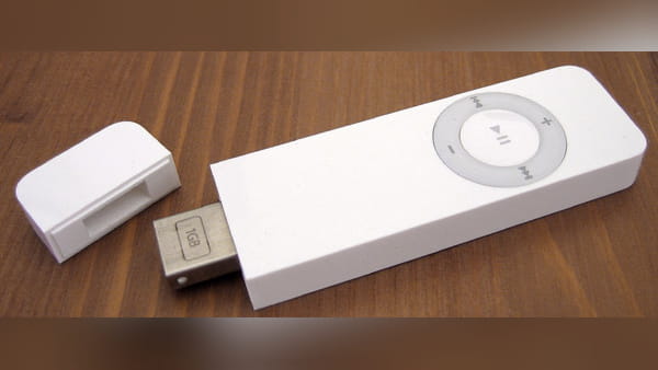 An original Apple iPod Shuffle on a desk.
