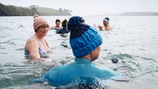 Group of women swimming in the sea in winter