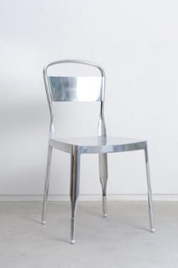 Silver coloured chair with white wall