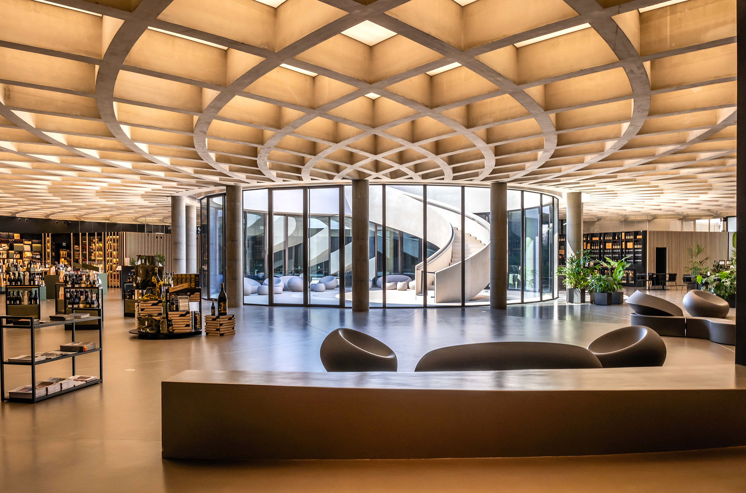 Interior of the Masi winery, with large curved windows and modern seating
