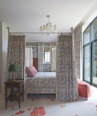 bedroom with patterned fabric and four poster sursound with curtains