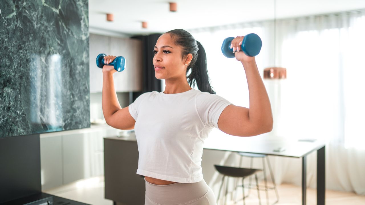 A woman performing a shoulder press