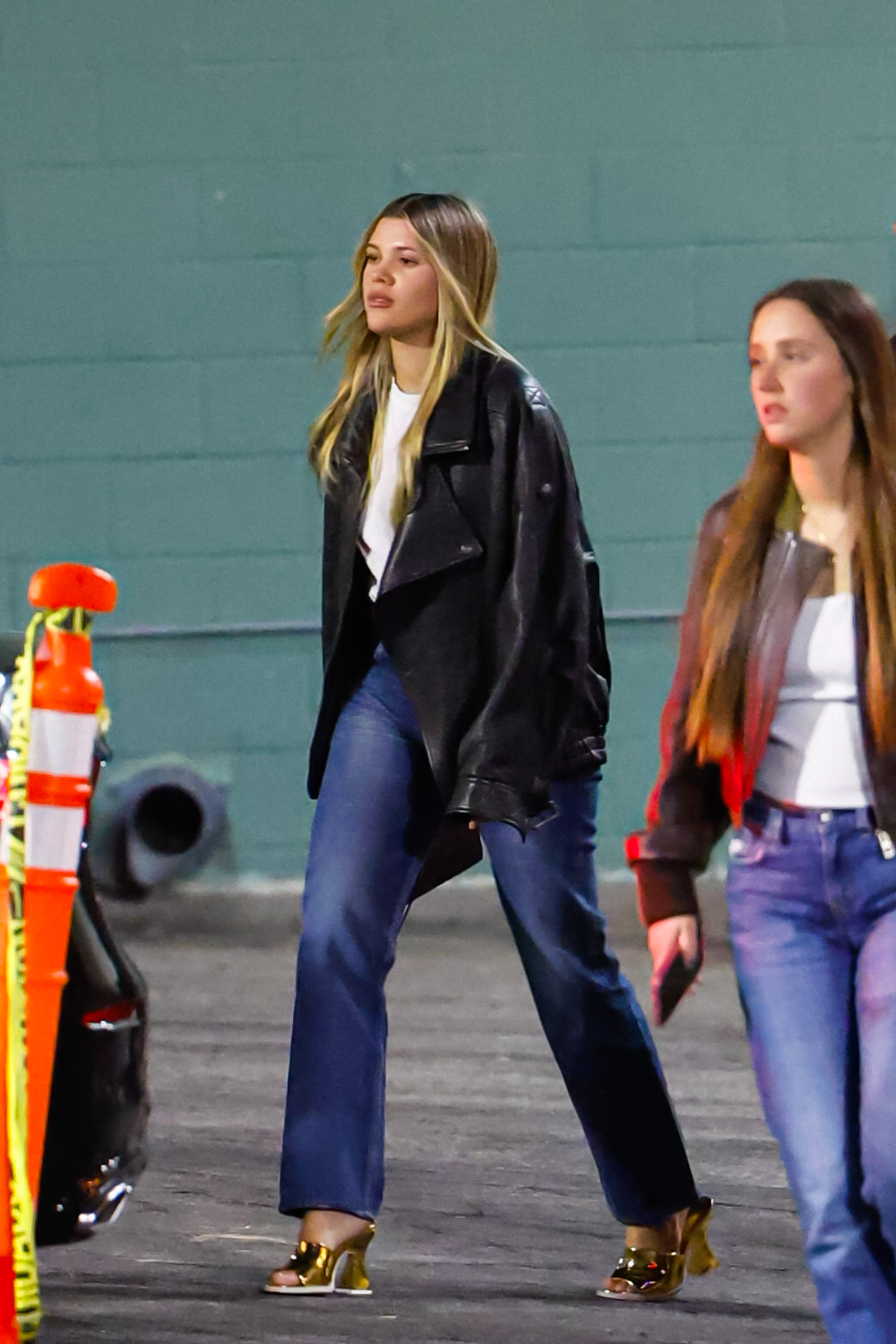 Sofia Richie is seen attending Paris Hilton's concert at The Hollywood Palladium on October 24, 2024 in Los Angeles, California wearing a black leather jacket, jeans, and gold mules.