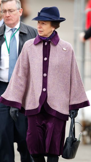 Princess Anne walks holding her handbag as she attends day 2, Ladies Day, of the Cheltenham Festival on March 16, 2016