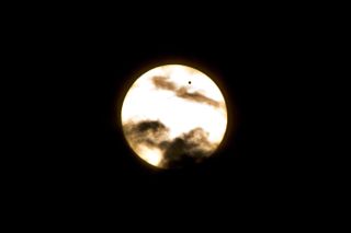 Venus Crossing the Sun in the Clouds