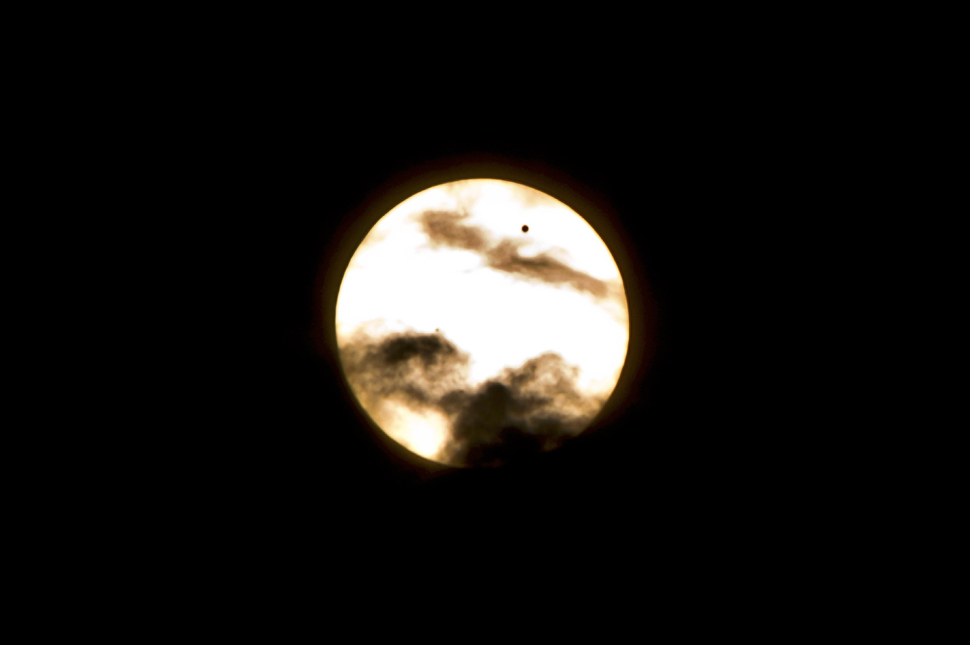 Venus Crossing the Sun in the Clouds