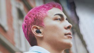 Man wearing Sony WF-C700N earbuds.