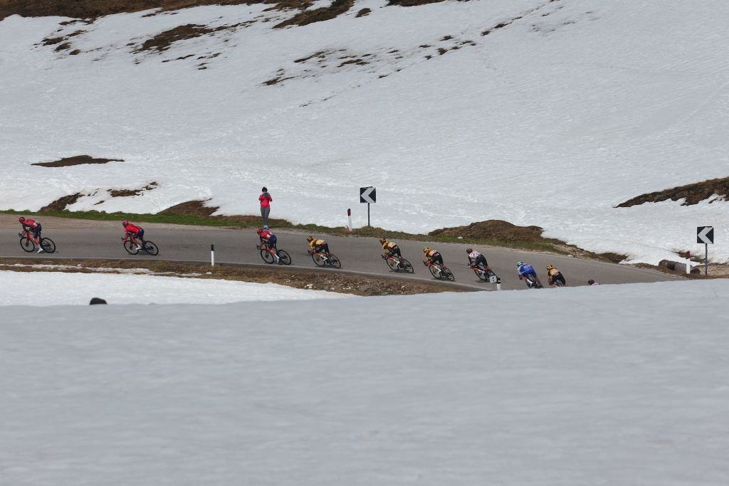 The pack of riders cycles down the Passo Giau pass in the Dolomites mountains during the nineteenth stage of the Giro dItalia 2023 cycling race 183 km between Longarone and Tre Cime di Lavaredo rifugio Auronzo on May 26 2023 Photo by Luca Bettini AFP Photo by LUCA BETTINIAFP via Getty Images