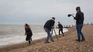 People film on a beach