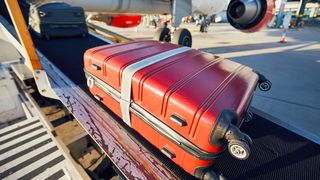 Luggage being transported to a plane.