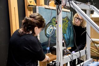 Scientists Emeline Pouyet of Northwestern University (left) and Sandra Webster-Cook of the Art Gallery of Ontario set up the X-ray fluorescence instrument to scan Picasso's "La Miséreuse accroupie."