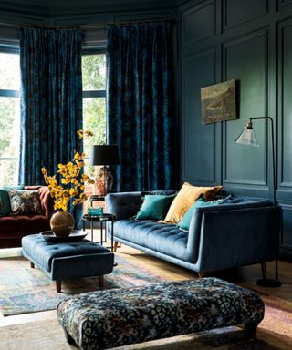 Teal living room with teal sofa, ottoman and painted walls