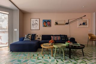 a colorful living room with a navy blue sofa