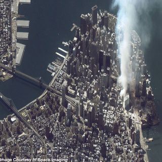 This one-meter resolution satellite image of Manhattan, New York was collected at 11:43 a.m. EDT on Sept. 12, 2001 by Space Imaging's IKONOS satellite. The image shows an area of white and gray-colored dust and smoke at the location where the 1,350-foot towers of the World Trade Center once stood. Since all airplanes were grounded over the U.S. after the attack, IKONOS was the only commercial high-resolution camera that could take an overhead image at the time.