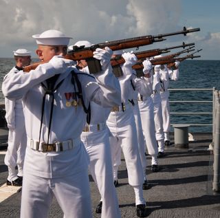 A US Navy firing squad fires three volleys in honor of Neil Armstrong during his burial at sea service aboard the USS Philippine Sea (CG 58), Friday, Sept. 14, 2012.