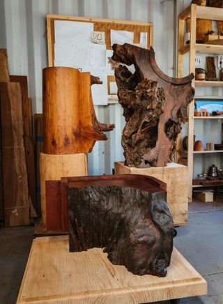 Ido Yoshimoto's workshop in Inverness, California, photographed under a blue sky and with wooden elements from his production