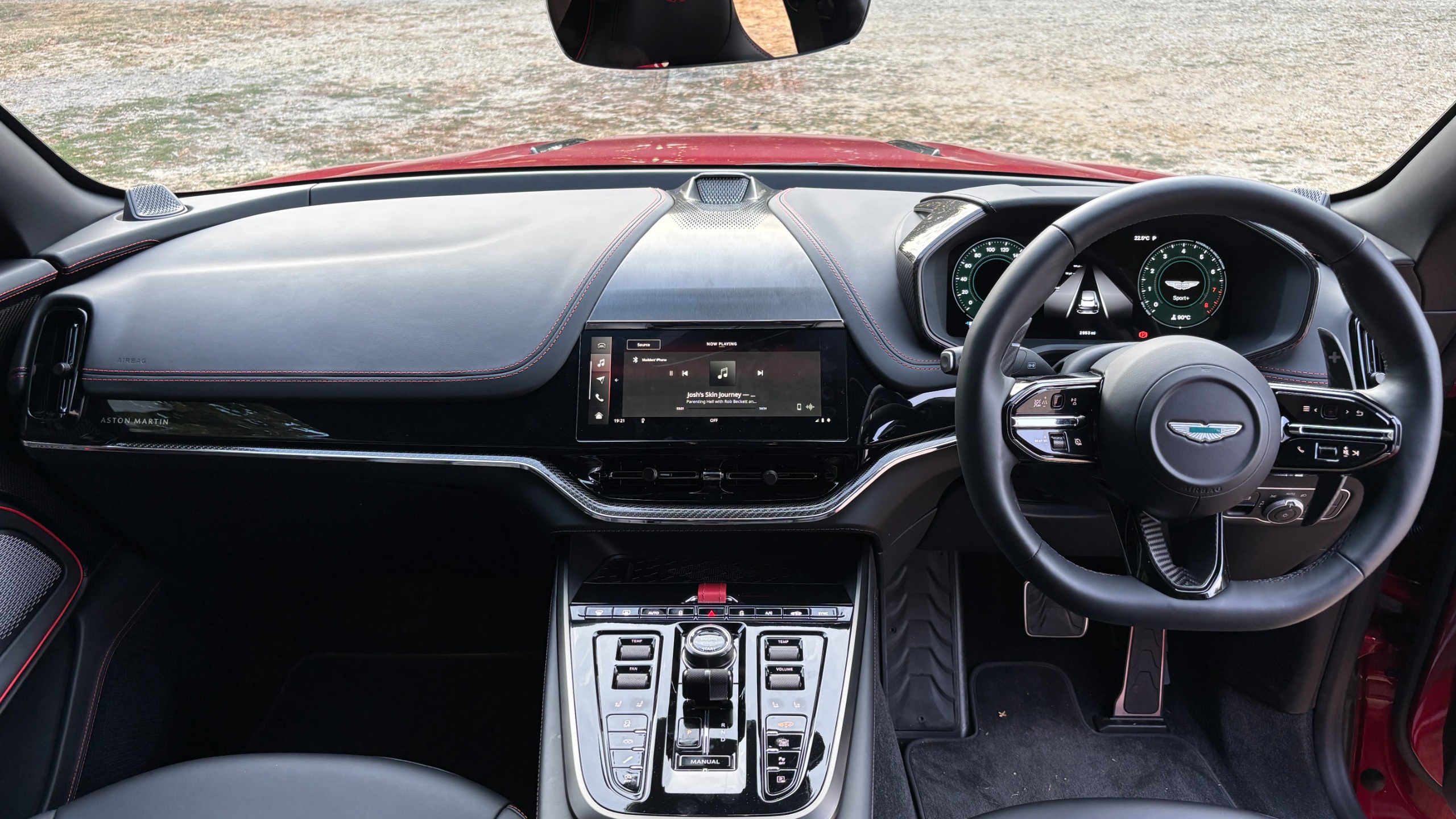 The view from the back seat of an Aston Martin DBX S, showing the centre console