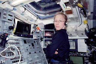 NASA astronaut Marsha Ivins is seen aboard the aft flight deck of space shuttle Atlantis during the STS-98 mission in 2001.