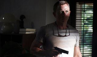 No Time To Die Daniel Craig in shadow, with a gun