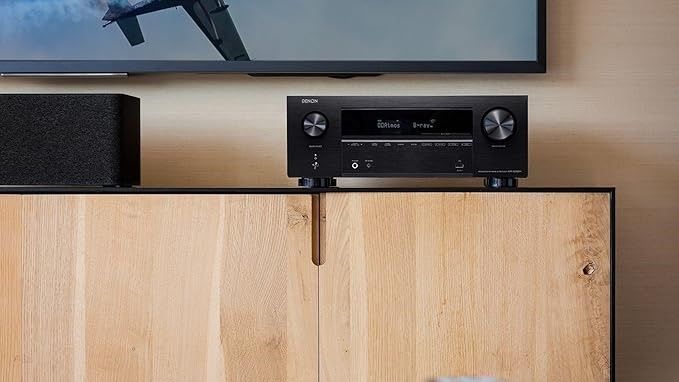 A Denon AVR on a modern wooden media unit