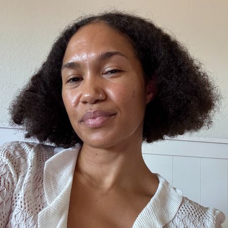 A beauty editor with curly hair wearing JVN hair products