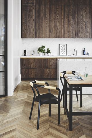 Wooden kitchen with marble island and dining table