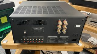 Copland CTA407 stereo amplifier on wooden hi-fi rack rear view showing connections