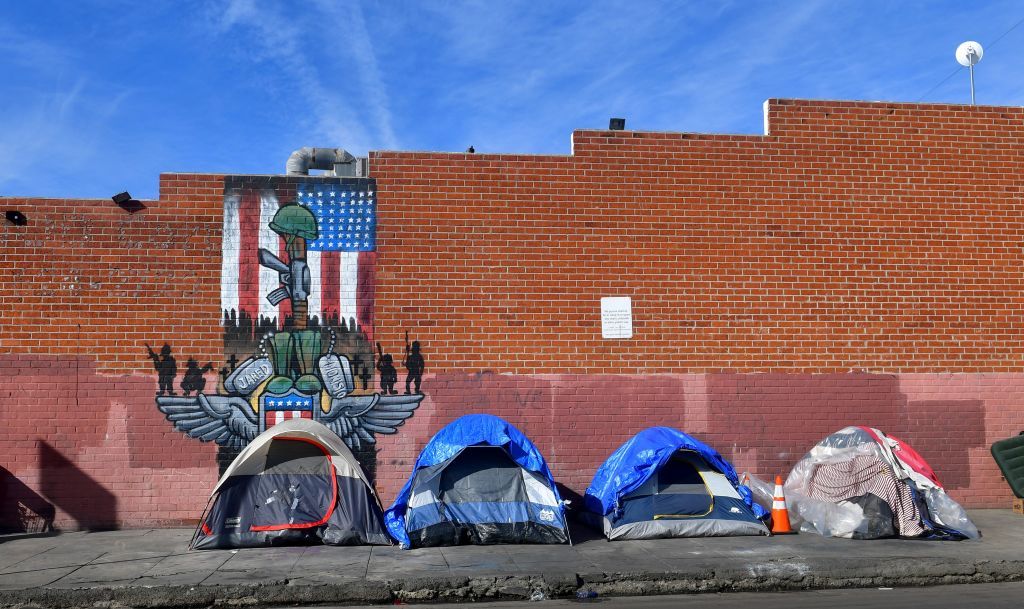 Tents for the homeless line a sidewalk in Los Angeles.