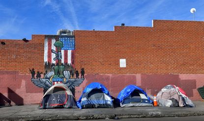 Tents for the homeless line a sidewalk in Los Angeles.