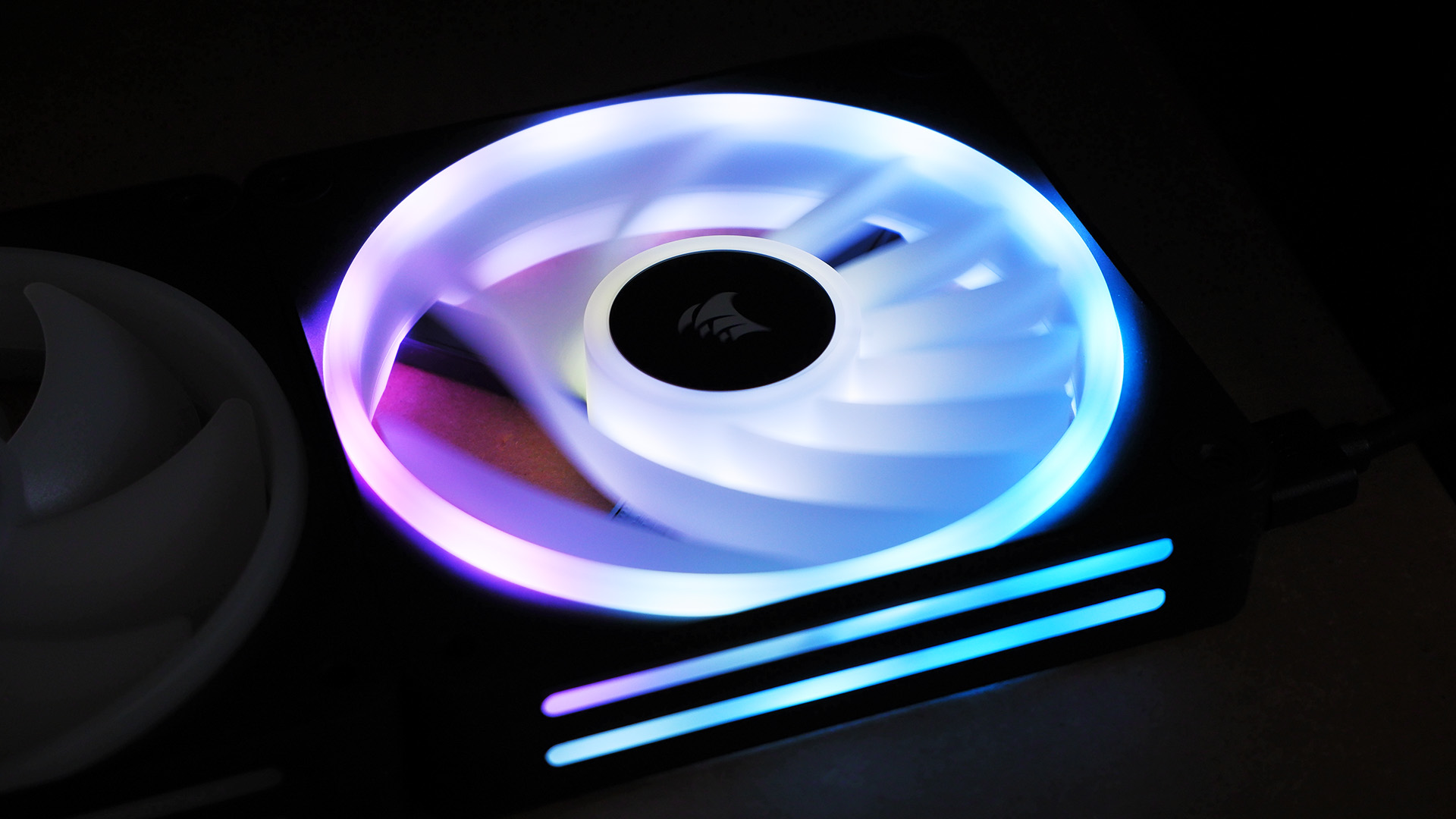 Corsair iCUE Link QX120 RGB setup on a desk.