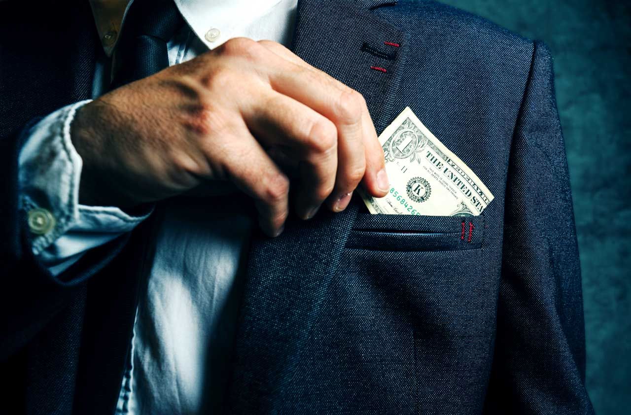 Businessman putting dollar banknotes money in his suit pocket, elegant businessperson with cash.