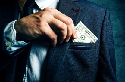 Businessman putting dollar banknotes money in his suit pocket, elegant businessperson with cash.
