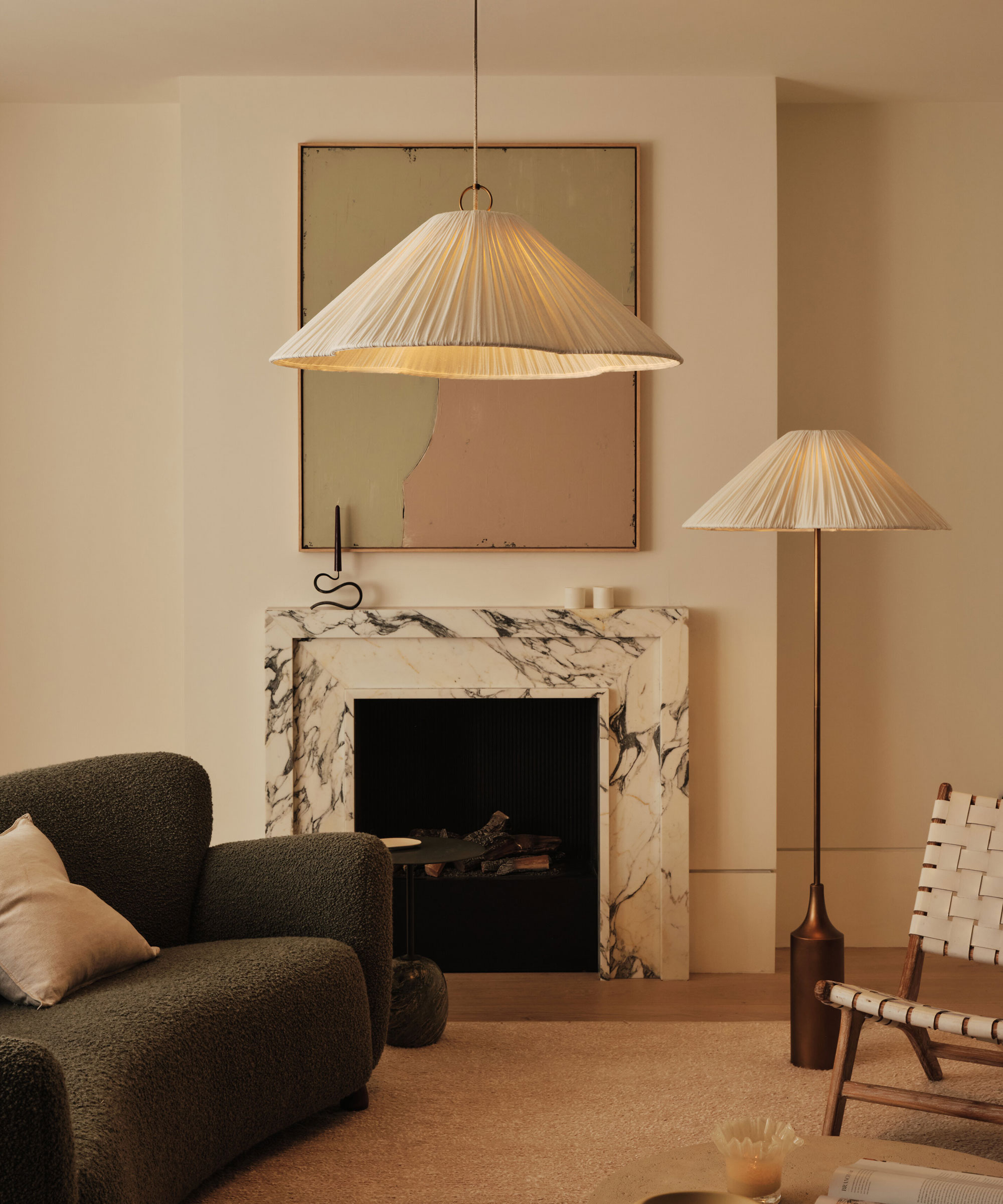 neutral living room with oversized pendant light and matching floor lamp and marble fireplace