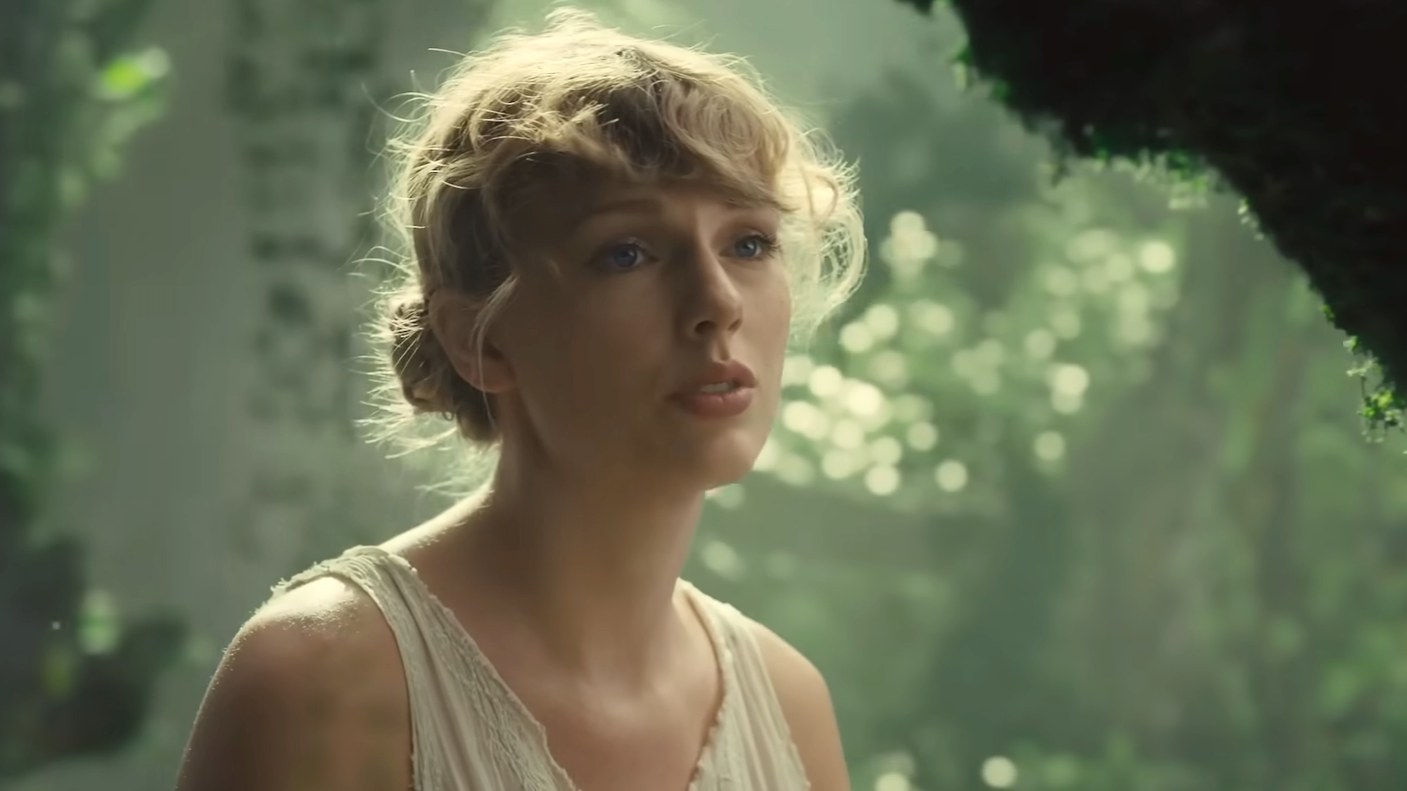 Taylor Swift singing "Cardigan" in the music video.
