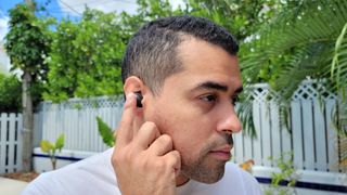 Man touching Samsung Galaxy Buds 2 in ears