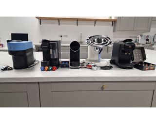 A wide shot of various pod coffee machines including the Nespresso pod