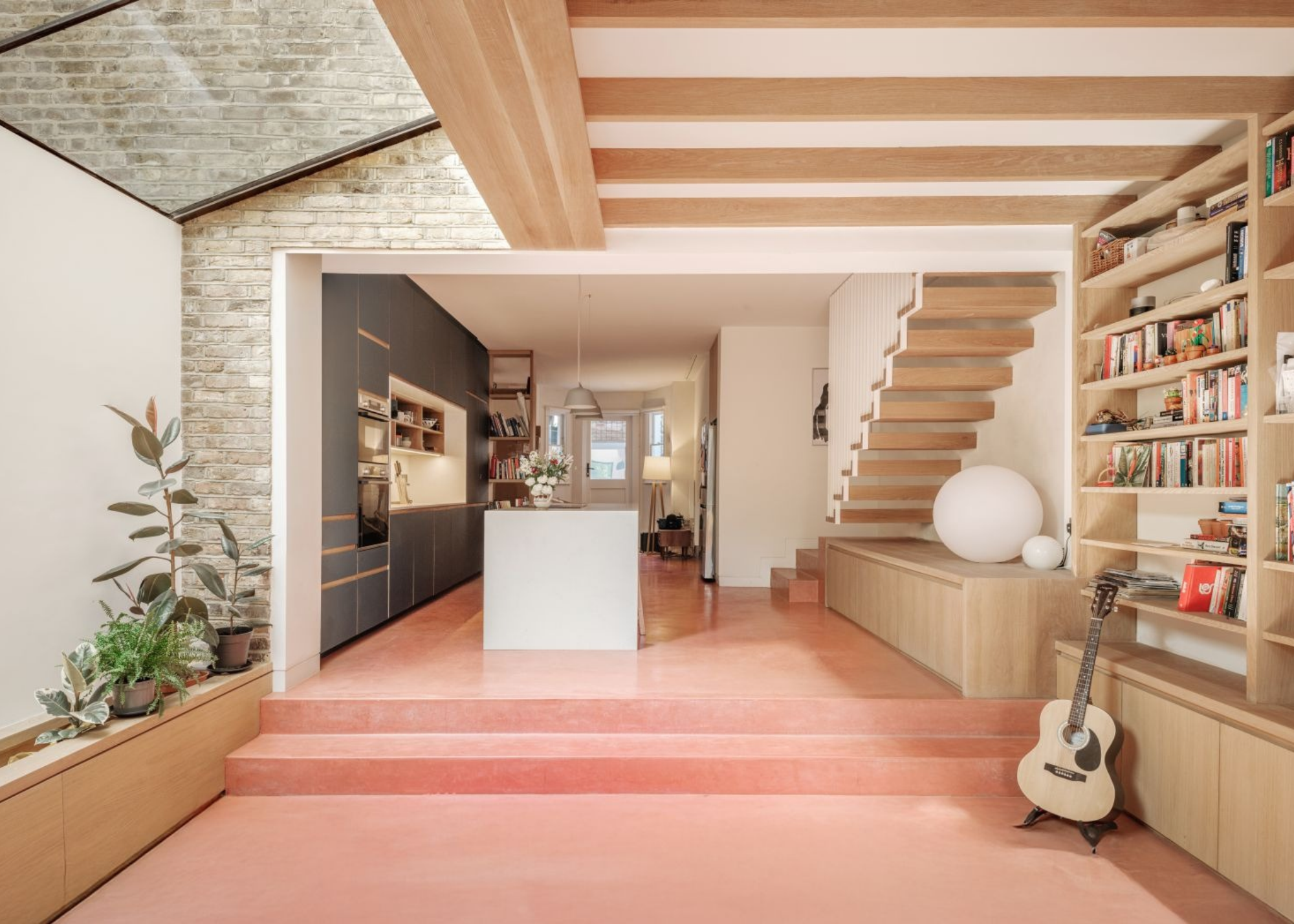 a modern kitchen extension with pink poured concrete floors