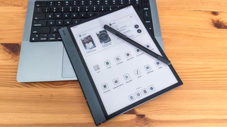 The Boox Note Air5 C and the Boox Pen 3 sitting on top of a laptop keyboard