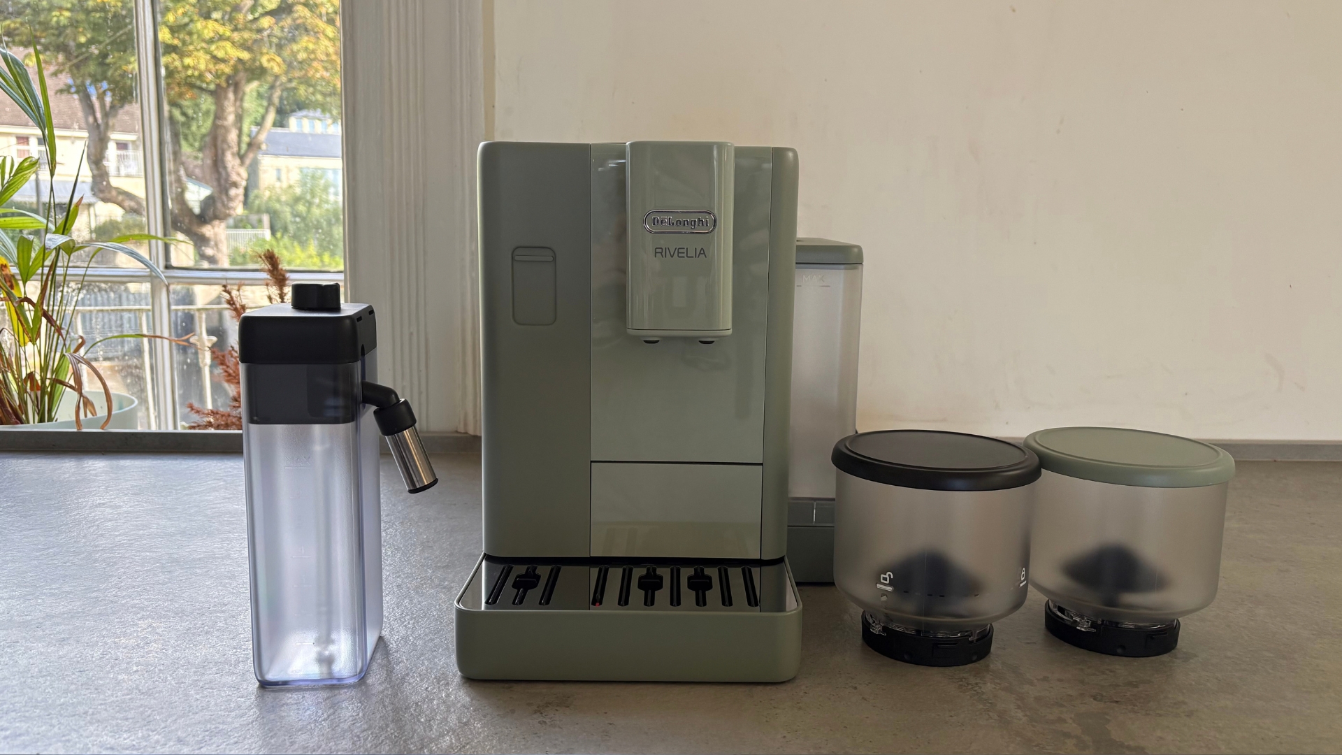 De'Longhi Rivelia Start Coffee Machine on the counter with the accessories