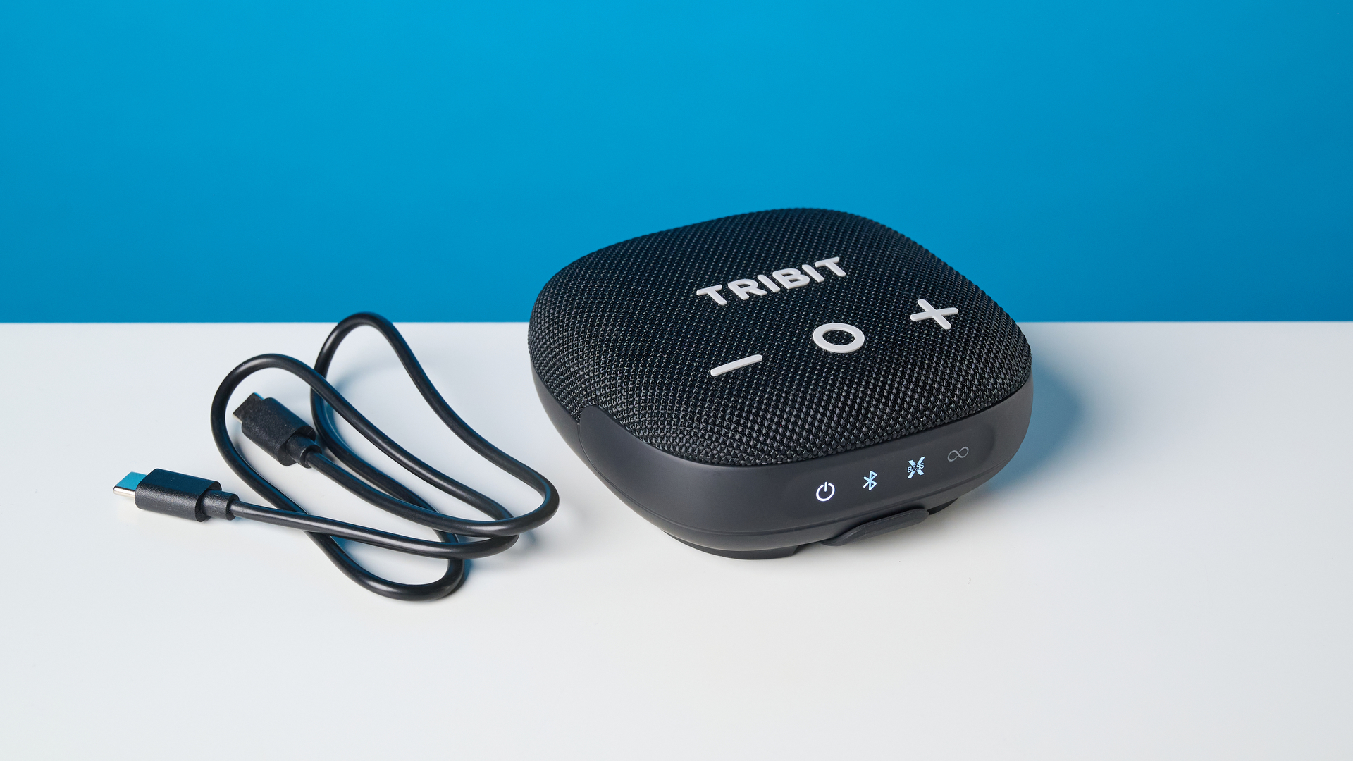 Tribit StormBox Micro 3 in black photographed in front of a blue background