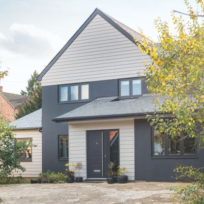 Contemporary family home exterior with grey painted walls and wood cladding