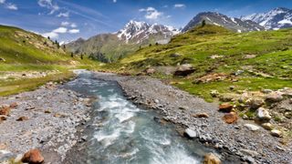 A stream with mountains in the background