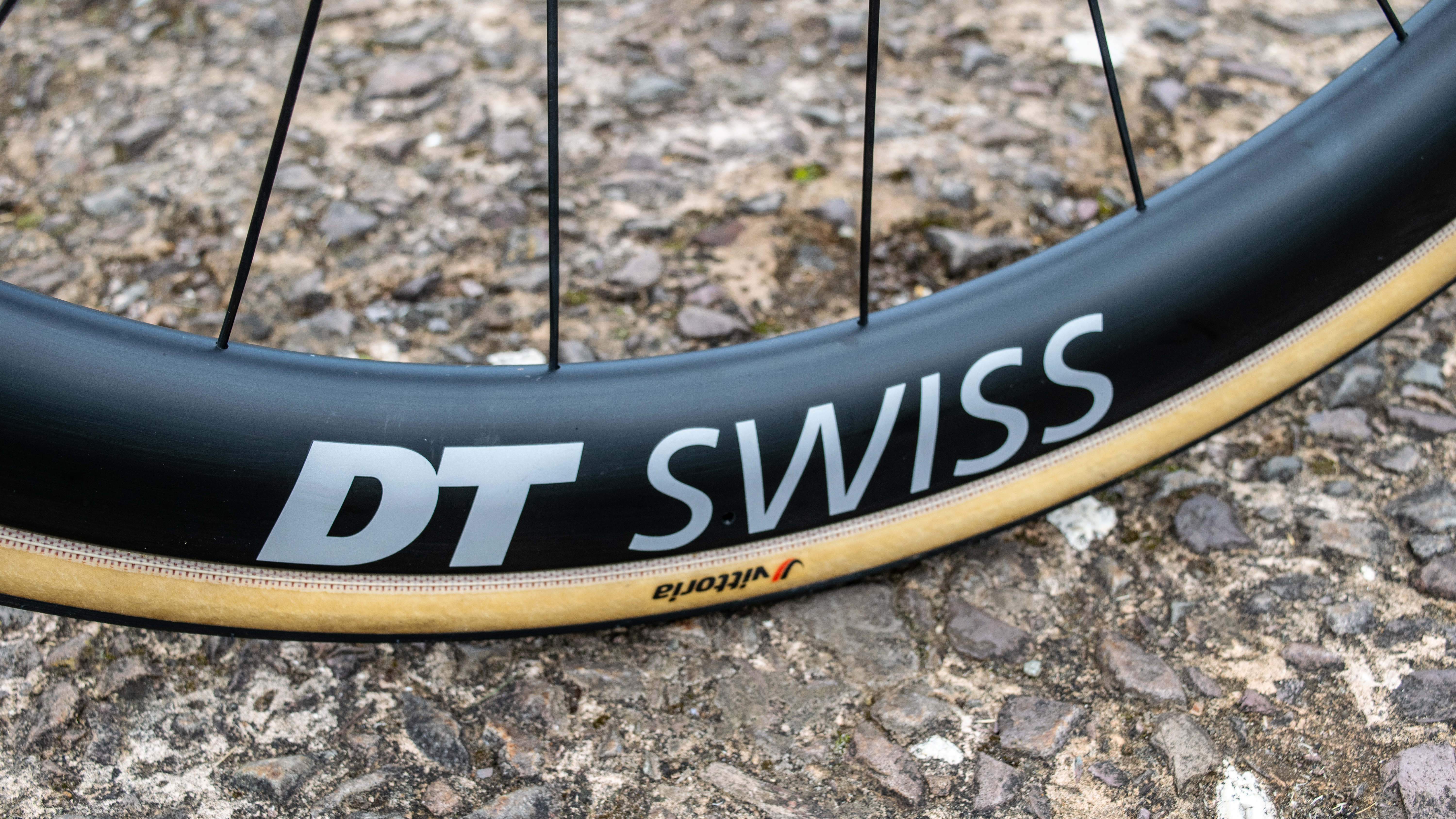 A DT Swiss carbon rim on a concrete floor