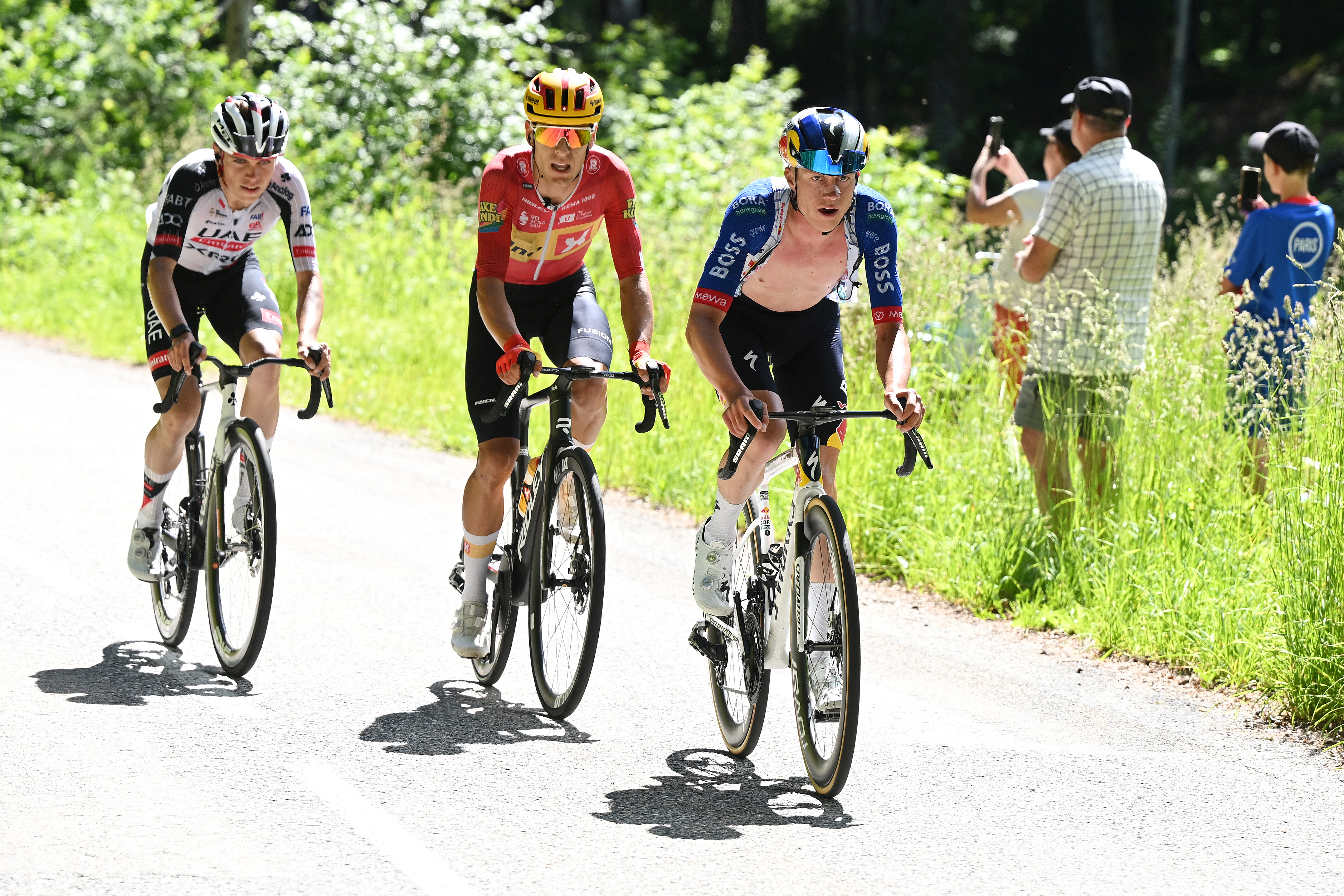 CREST-VOLAND, FRANCE - JUNE 12: (L-R) Pablo Torres of Spain and UAE Team Emirates - XRG, Tobias Halland Johannessen of Norway and Team Uno-X Mobility and Maxim Van Gils of Belgium and Team Red Bull - BORA - hansgrohe attack in the breakaway during the 78th Tour Auvergne-Rhone-Alpes 2026, Stage 6 a 182.3km stage from Saint-Vulbas to Crest-Voland 1211m / #UCIWT / on June 12, 2026 in Crest-Voland, France. (Photo by Dario Belingheri/Getty Images)