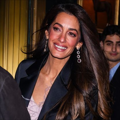 George Clooney and Amal Clooney leave the Polo Bar on December 14, 2023 in New York City. 