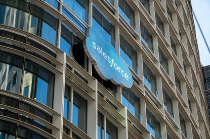 Blue cloud sign with Salesforce logo hanging on building