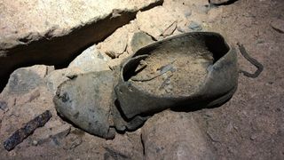 The remains of a shoe found in an old mine in northwestern England. It is a single black shoe and in fairly good condition, although it is rather worn looking.