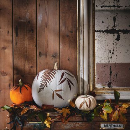 A selection of gourds and pumpkins decorated with leaf prints for Halloween