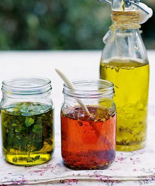 Chilli and herb oil in glass jars